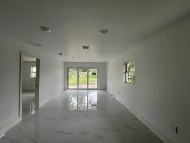 a view with cabinets a sink and a refrigerator
