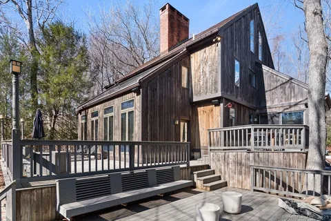 a view of deck with a large window and wooden floor