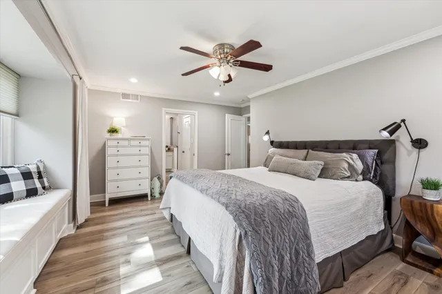 a spacious bedroom with a bed and ceiling fan