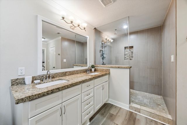 a bathroom with a granite countertop sink mirror and