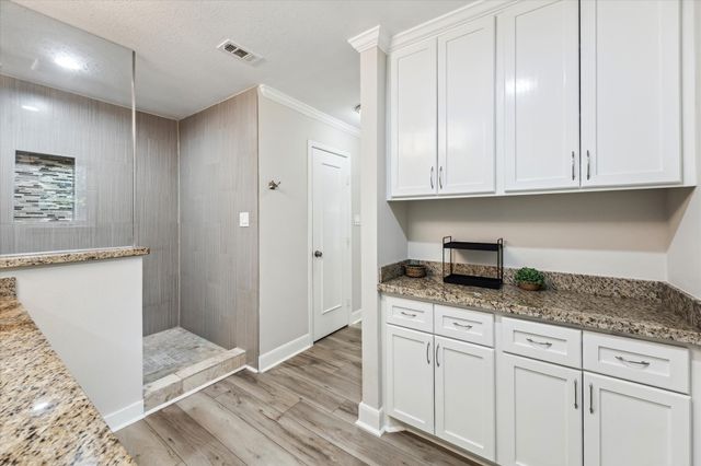 a kitchen with granite countertop cabinets and window
