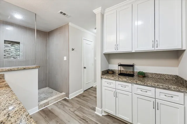 a kitchen with granite countertop cabinets and window