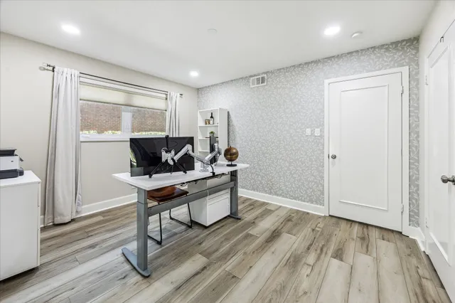 a living room with wooden floor and furniture