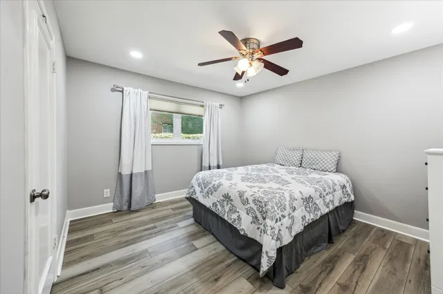 a bed sitting in a spacious bedroom next to a window