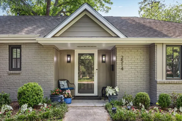 a view of a house with potted plants