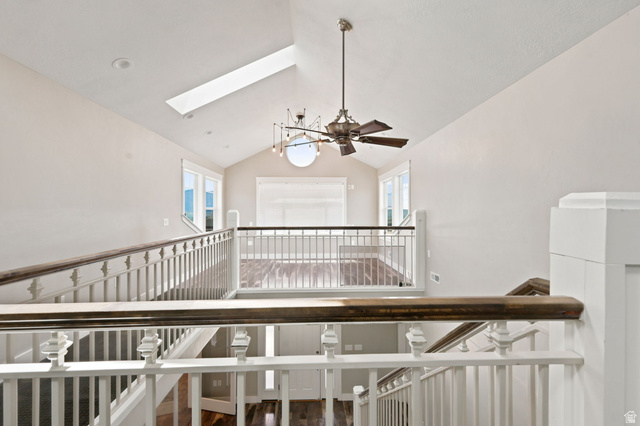 580 North 300 East Logan, UT 84321 - Photo 53 of 74 Upper-level landing featuring vaulted ceilings, a skylight, and an overhead light fixture with a ceiling fan