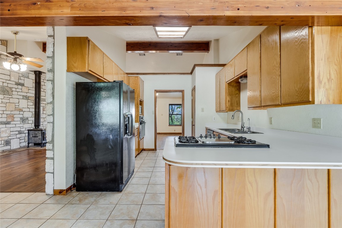 199 Middleton Road Spicewood, TX 78669 - Photo 12 of 39 a kitchen with refrigerator and cabinets