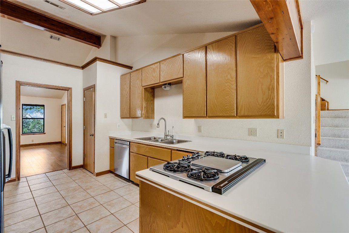 199 Middleton Road Spicewood, TX 78669 - Photo 13 of 39 a kitchen with stainless steel appliances granite countertop a stove and a sink