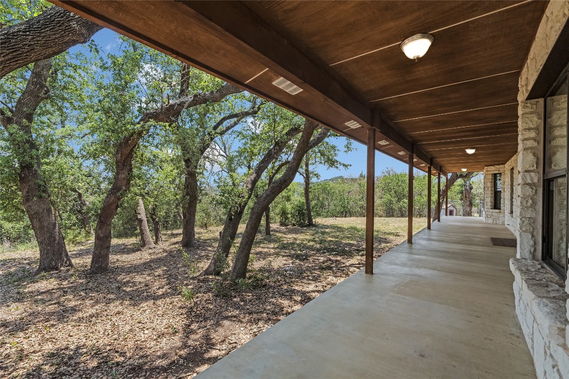199 Middleton Road Spicewood, TX 78669 - Photo 23 of 39 a view of a backyard with floor to ceiling window and tree