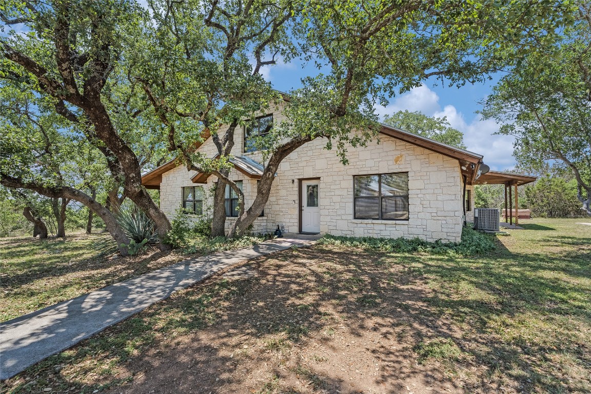 199 Middleton Road Spicewood, TX 78669 - Photo 24 of 39 a house with a tree in front of it