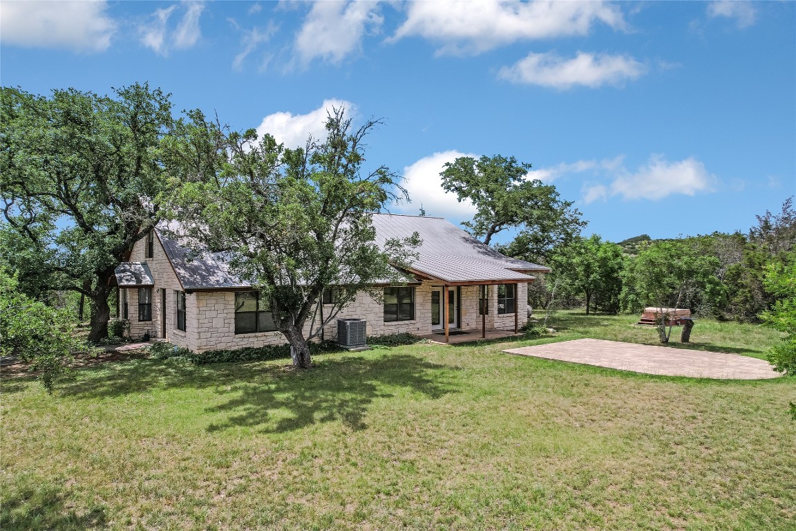 199 Middleton Road Spicewood, TX 78669 - Photo 3 of 39 a view of a house with a yard