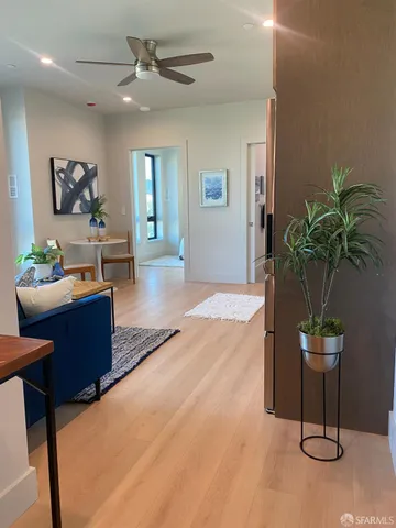 a living room with furniture a potted plant and a rug