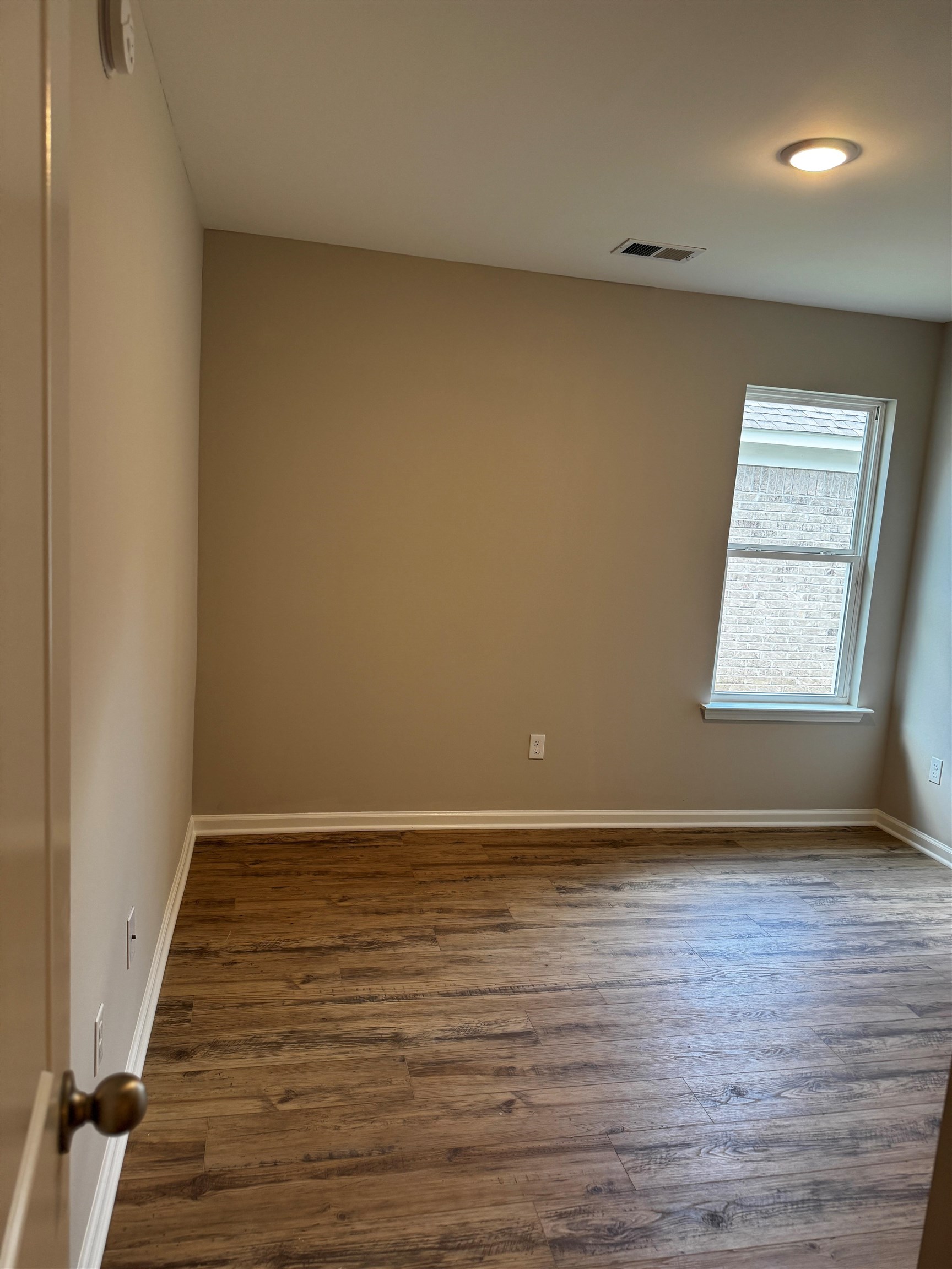 5283 Zodiac Road Memphis, TN 38118 - Photo 8 of 13 Room featuring wood-finish flooring, neutral wall tones, and white trim