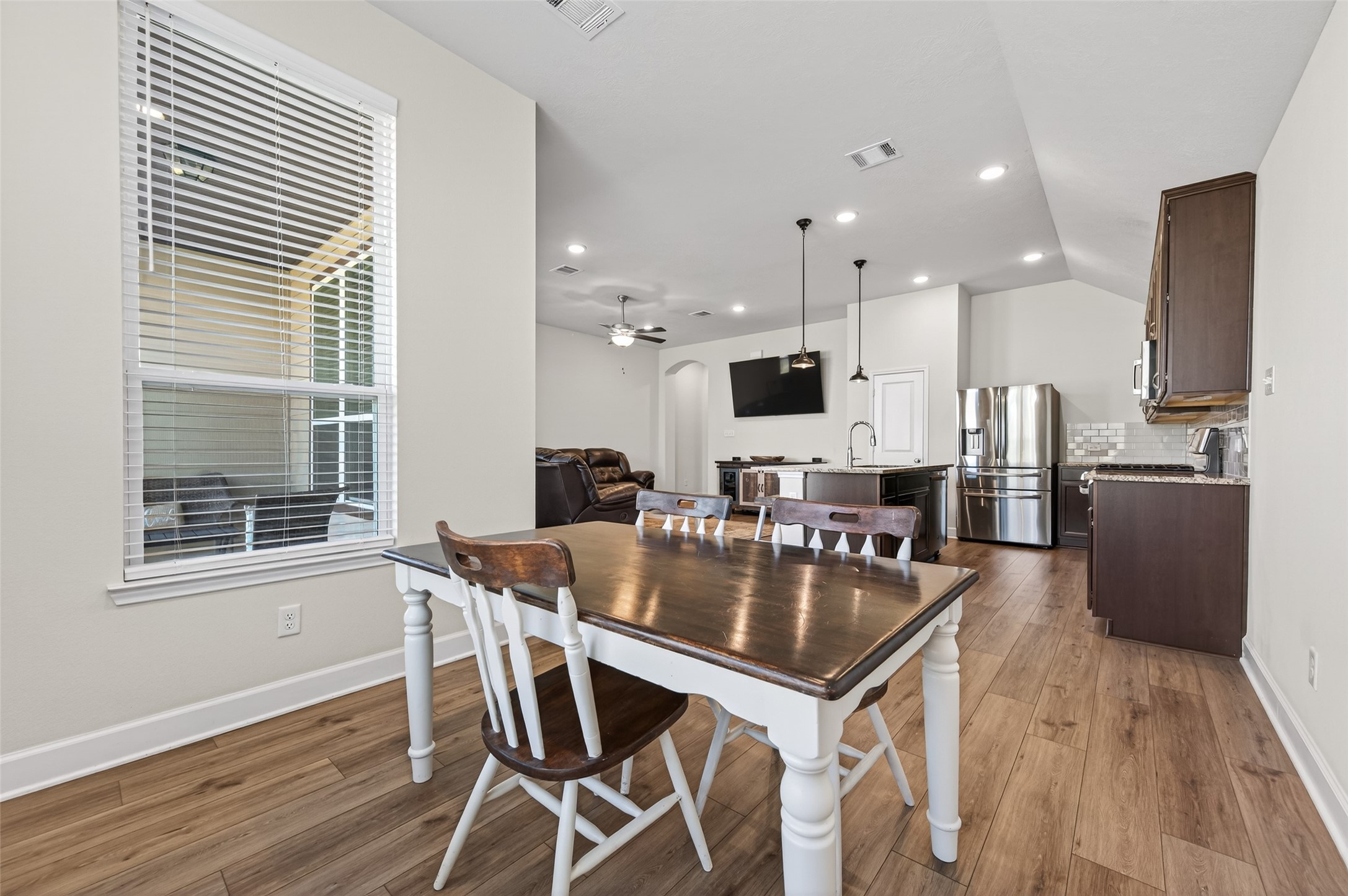 917 Farm Path Brenham, TX 77833 - Photo 20 of 43 a kitchen with granite countertop kitchen island wooden floor center island and stainless steel appliances