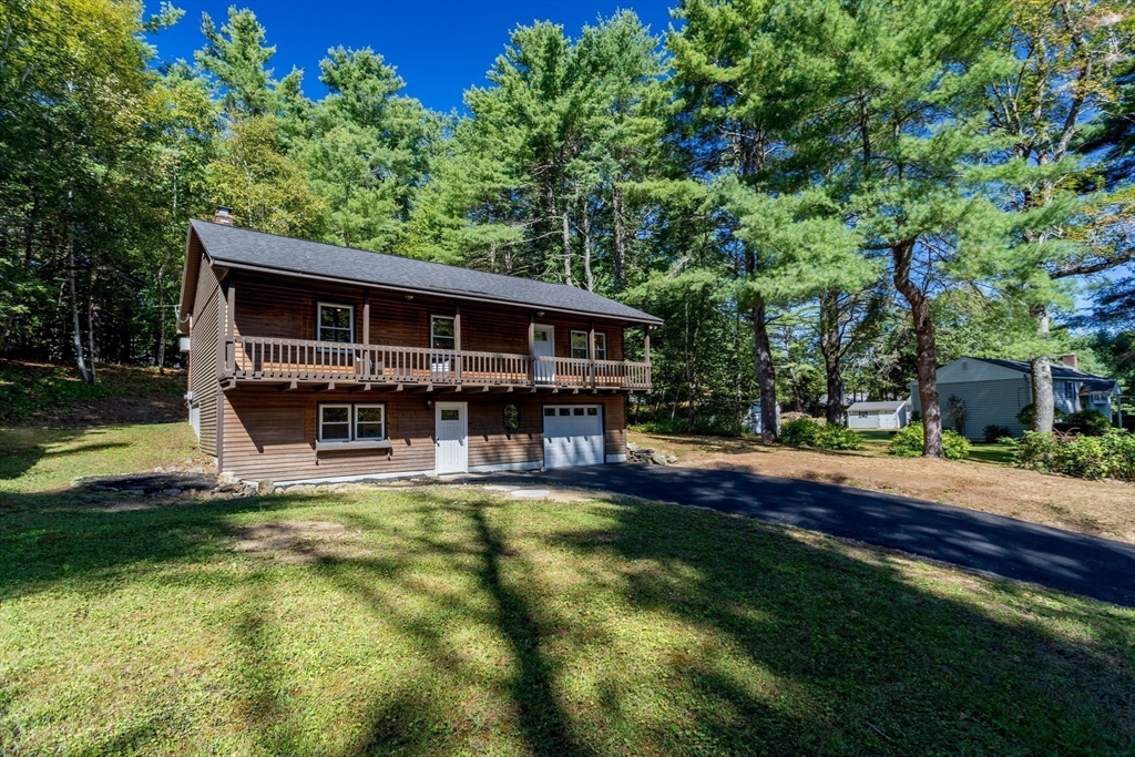 a view of a house with pool and sitting area