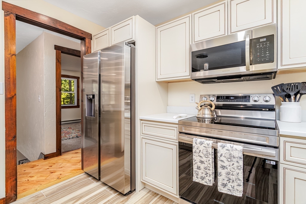 5 Kurikka Road Westminster, MA 01473 - Photo 5 of 38 a kitchen with stainless steel appliances granite countertop a refrigerator and a microwave