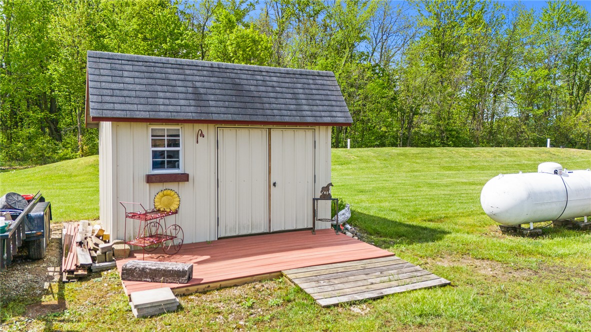 4222 Ramsey Road Springfield, OH 45502 - Photo 18 of 79 This charming shed offers practical outdoor storage with easy access and a picturesque natural backdrop.