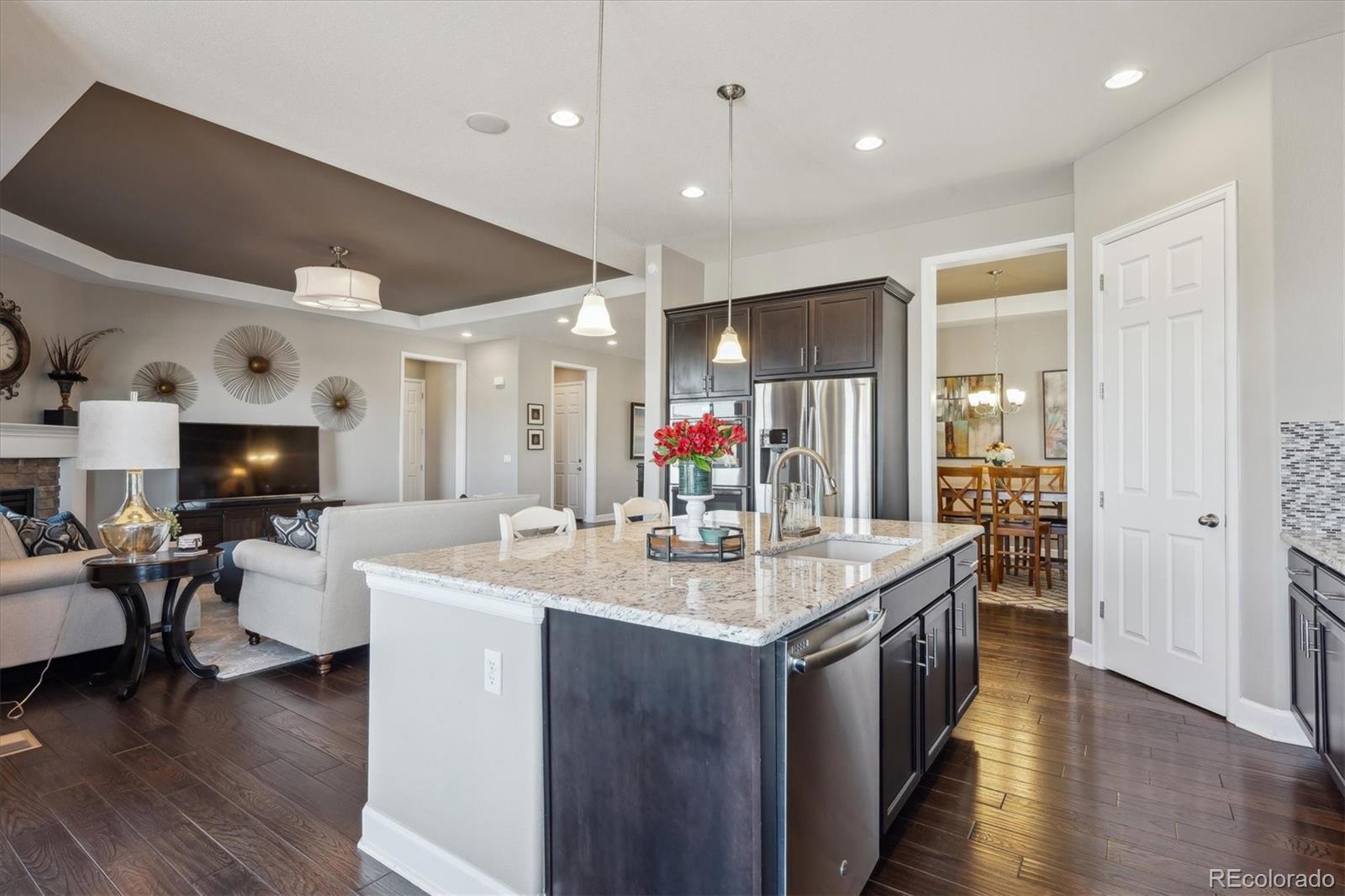 14100 Sierra Ridge Circle Parker, CO 80134 - Photo 11 of 37 a large kitchen with kitchen island a sink and a refrigerator