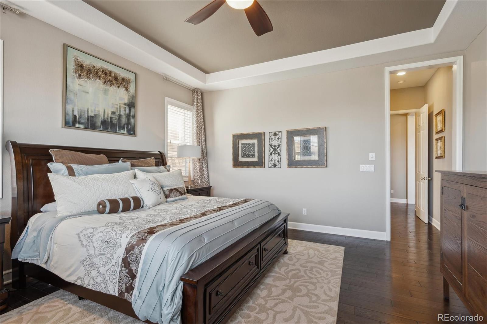 14100 Sierra Ridge Circle Parker, CO 80134 - Photo 13 of 37 a bedroom with bed and wooden floor