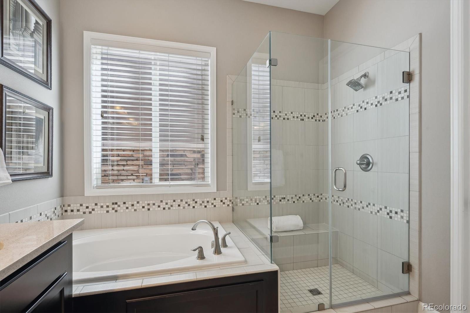 14100 Sierra Ridge Circle Parker, CO 80134 - Photo 16 of 37 a bathroom with a bathtub and a shower