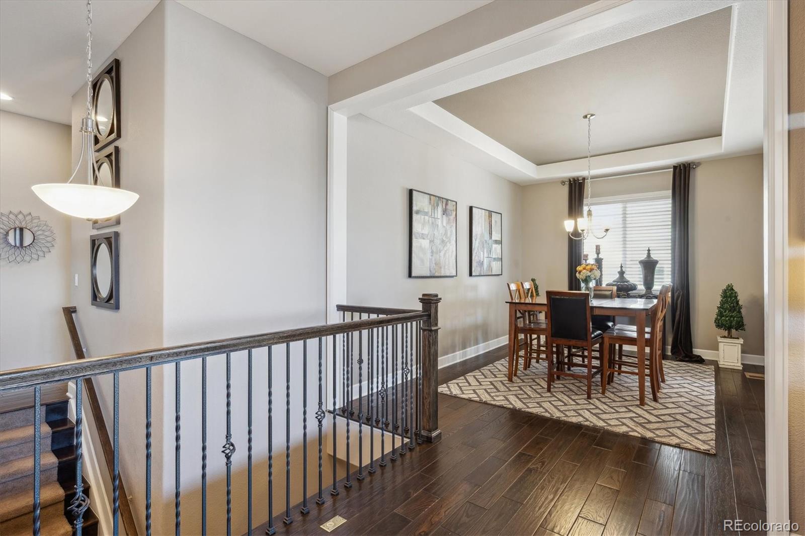 14100 Sierra Ridge Circle Parker, CO 80134 - Photo 17 of 37 a view of a dining room with furniture and wooden floor