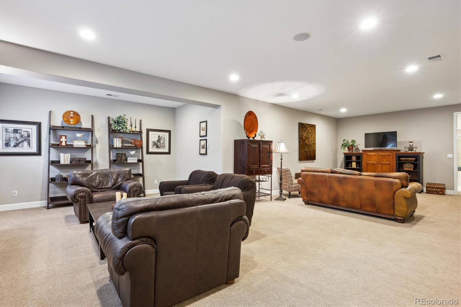 14100 Sierra Ridge Circle Parker, CO 80134 - Photo 25 of 37 a living room with furniture a couch and a flat screen tv
