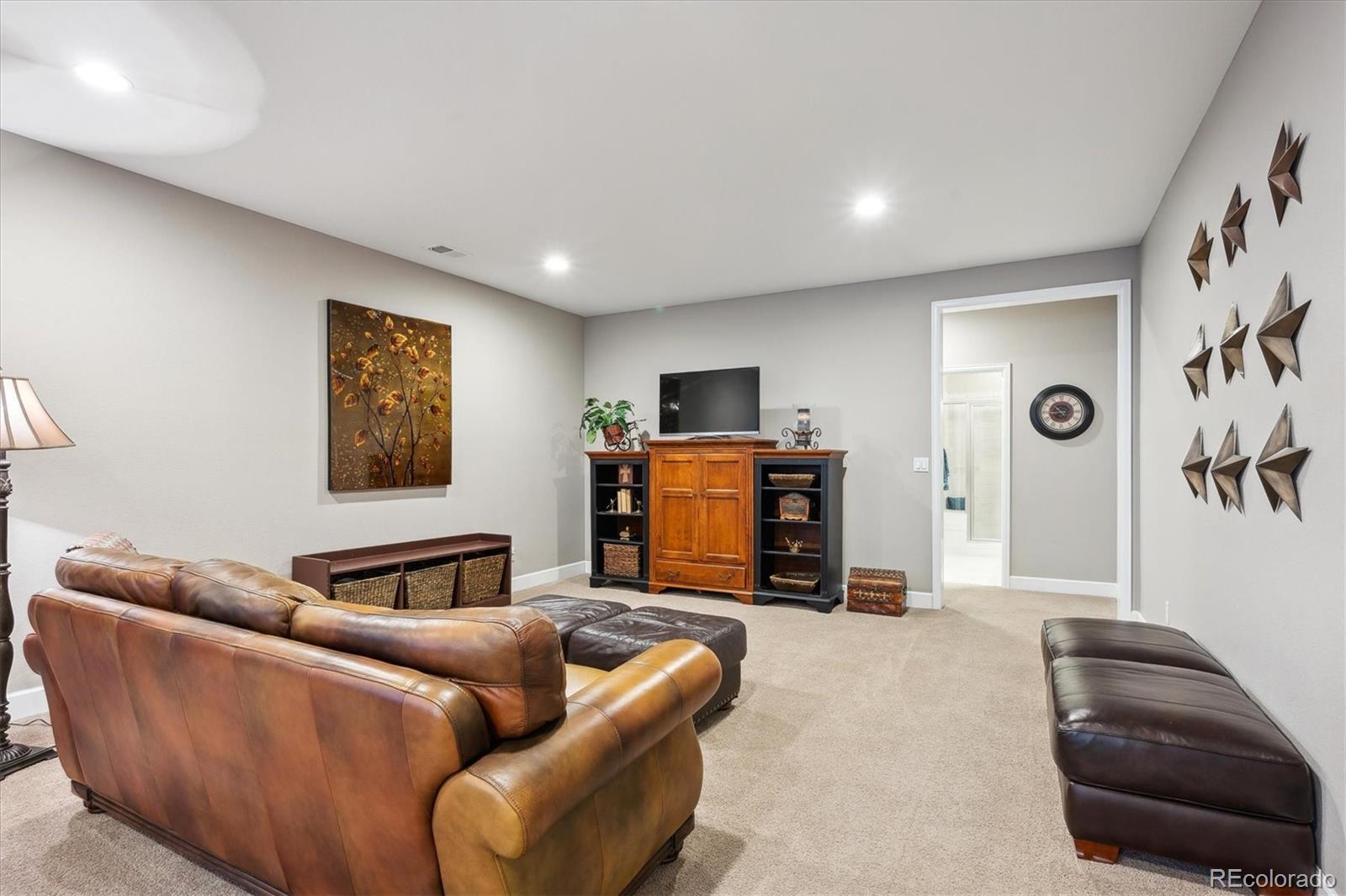 14100 Sierra Ridge Circle Parker, CO 80134 - Photo 28 of 37 a living room with furniture and a flat screen tv