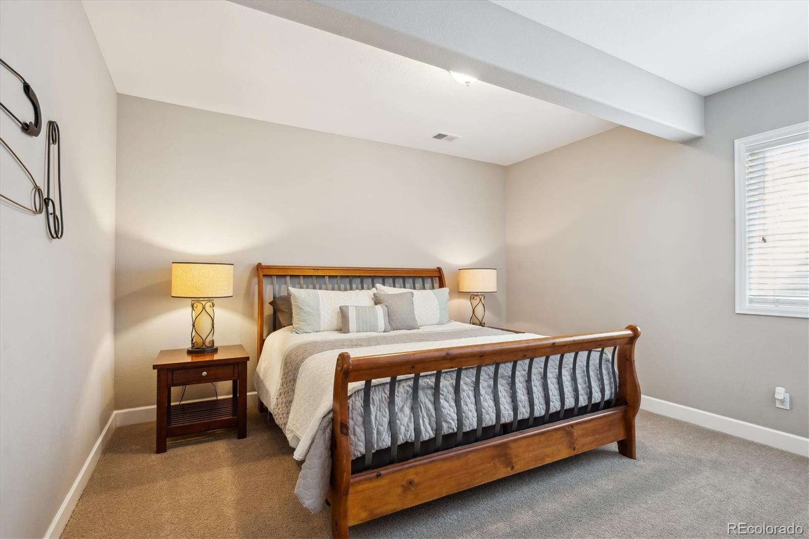 14100 Sierra Ridge Circle Parker, CO 80134 - Photo 30 of 37 a bed sitting in a bedroom next to a lamp