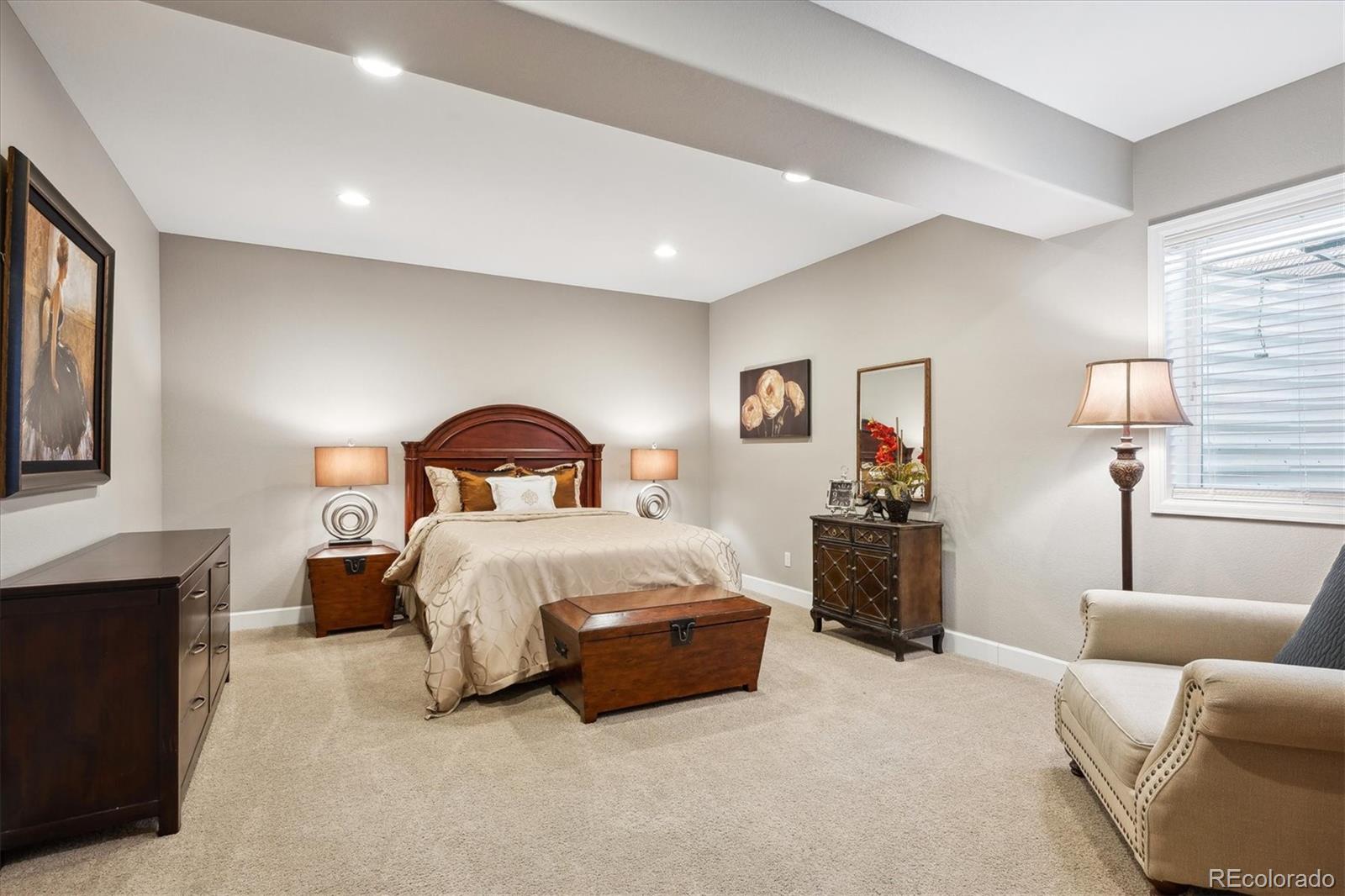 14100 Sierra Ridge Circle Parker, CO 80134 - Photo 31 of 37 a spacious bedroom with a bed and a couch