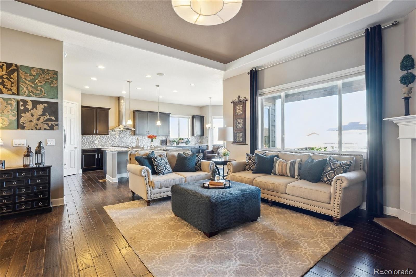 14100 Sierra Ridge Circle Parker, CO 80134 - Photo 8 of 37 a living room with fireplace furniture and a large window
