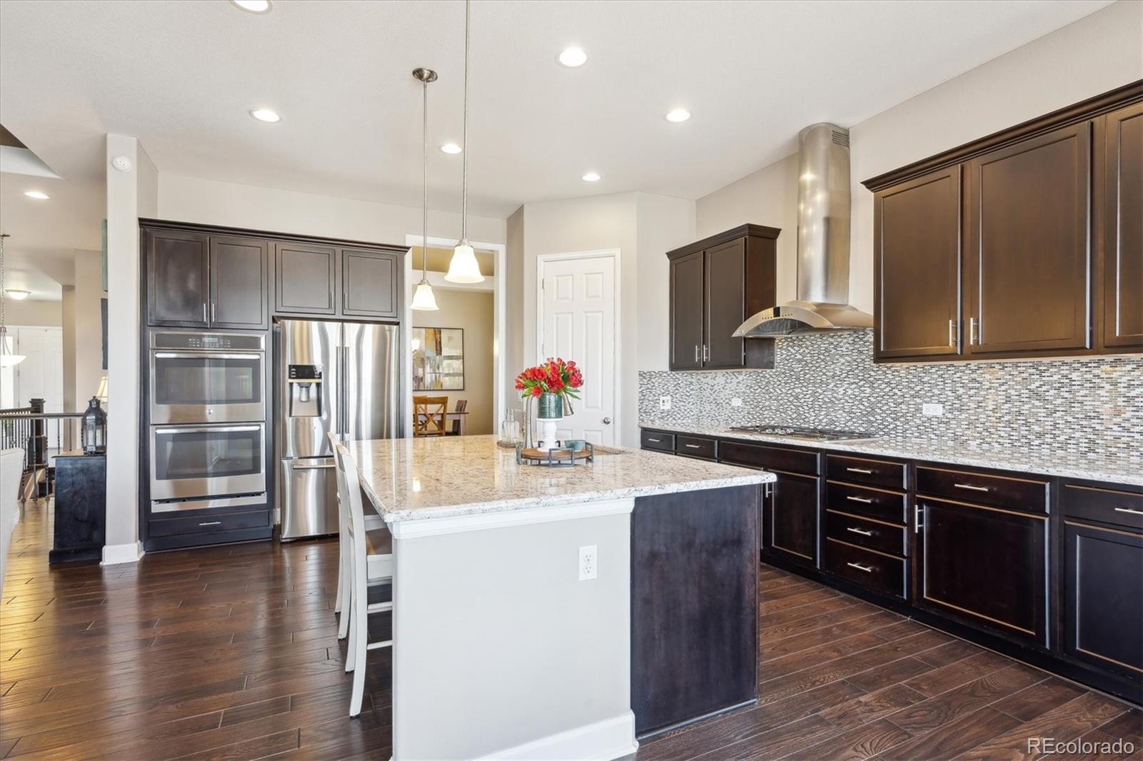 14100 Sierra Ridge Circle Parker, CO 80134 - Photo 10 of 37 a kitchen with stainless steel appliances granite countertop a sink stove and refrigerator