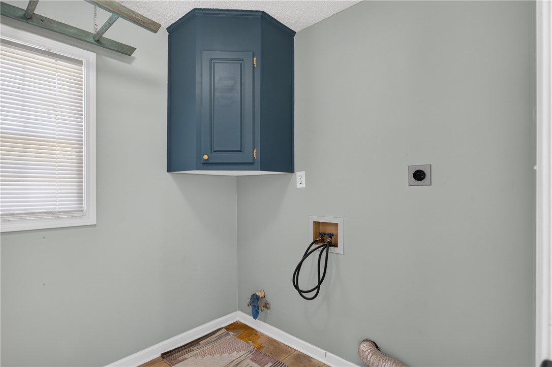 113 Greenfield Avenue Pendleton, SC 29670 - Photo 23 of 40 Functional laundry space featuring a window and wall-mounted cabinetry for essential storage.