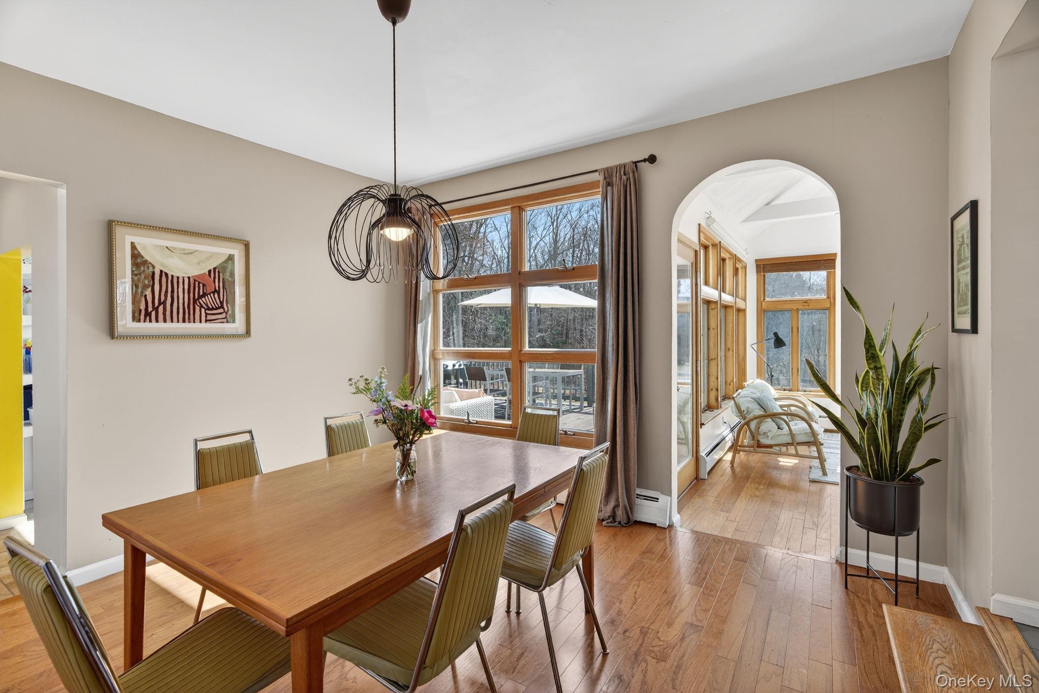 197 Hardenburgh Road Ulster Park, NY 12487 - Photo 13 of 35 a dining room with furniture a chandelier and wooden floor