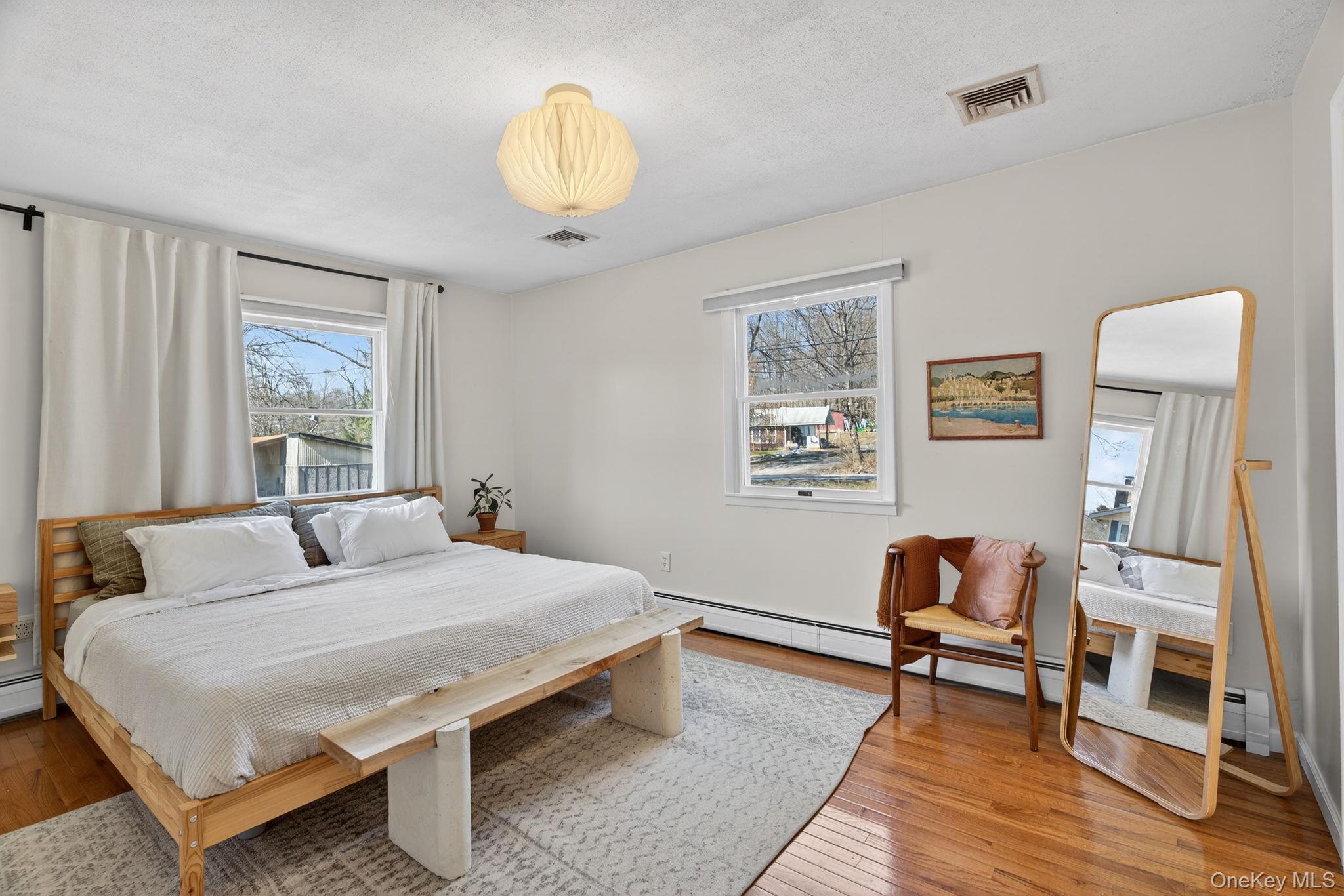 197 Hardenburgh Road Ulster Park, NY 12487 - Photo 23 of 35 a bedroom with a bed a painting on the wall and a window