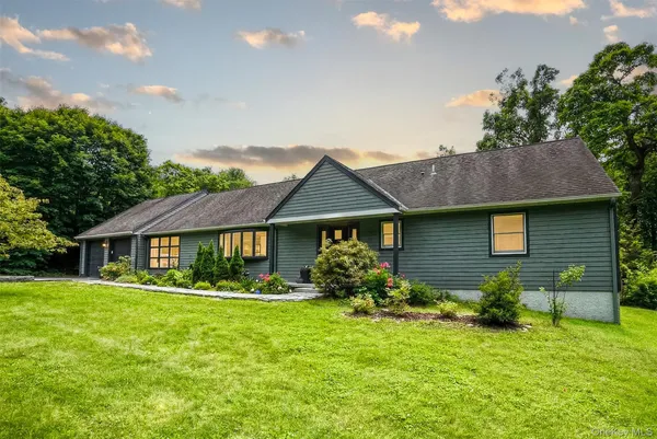 a front view of house with yard and green space