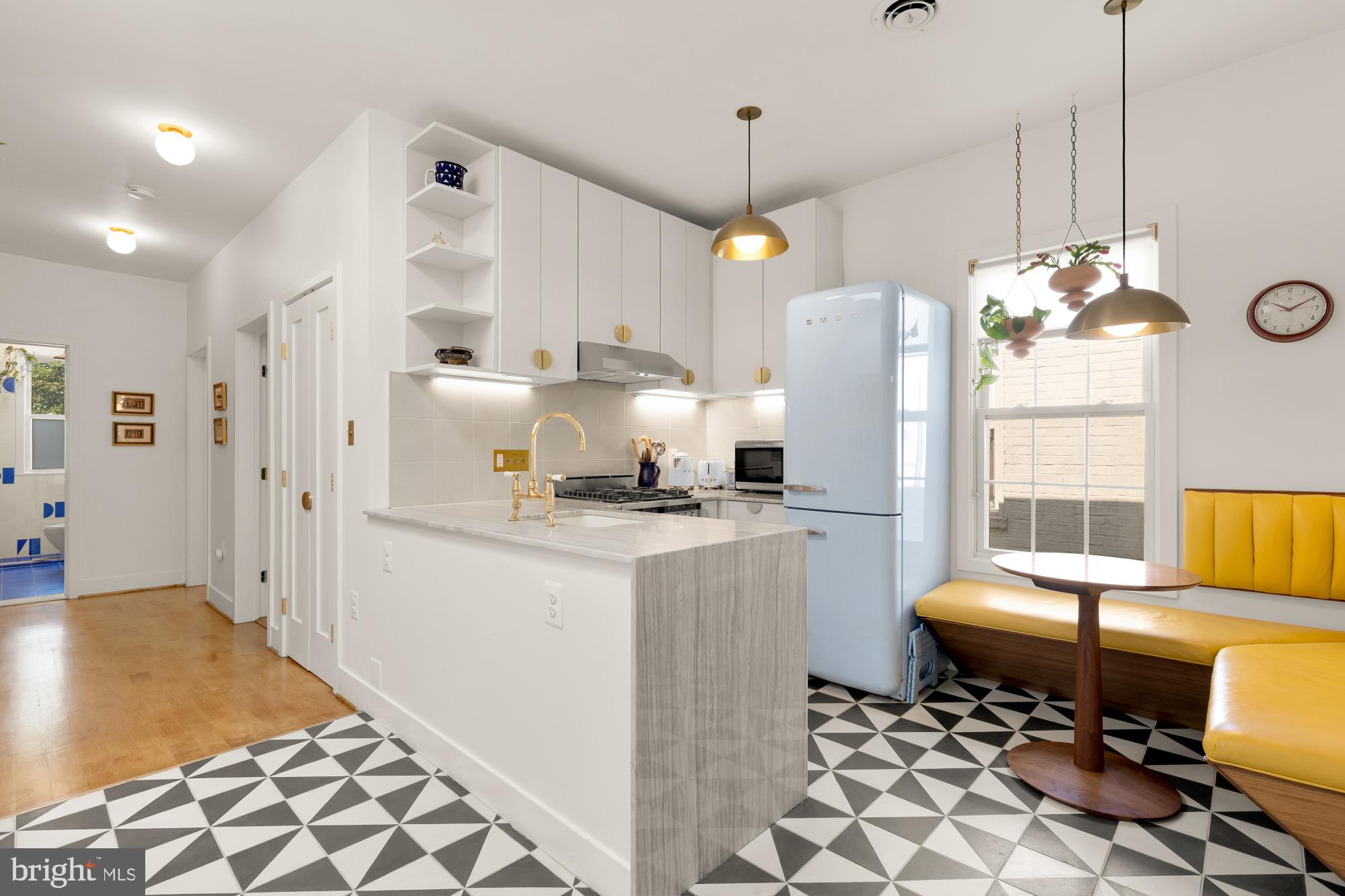 a kitchen with stainless steel appliances kitchen island granite countertop a refrigerator and a sink