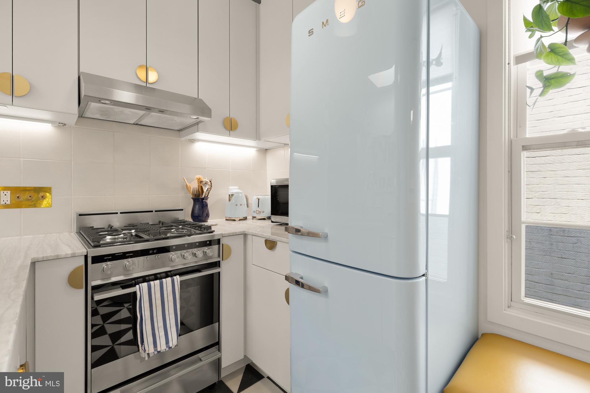 3022 R Street Northwest, Unit 3 Washington, DC 20007 - Photo 5 of 22 a kitchen with stainless steel appliances granite countertop a stove and a sink