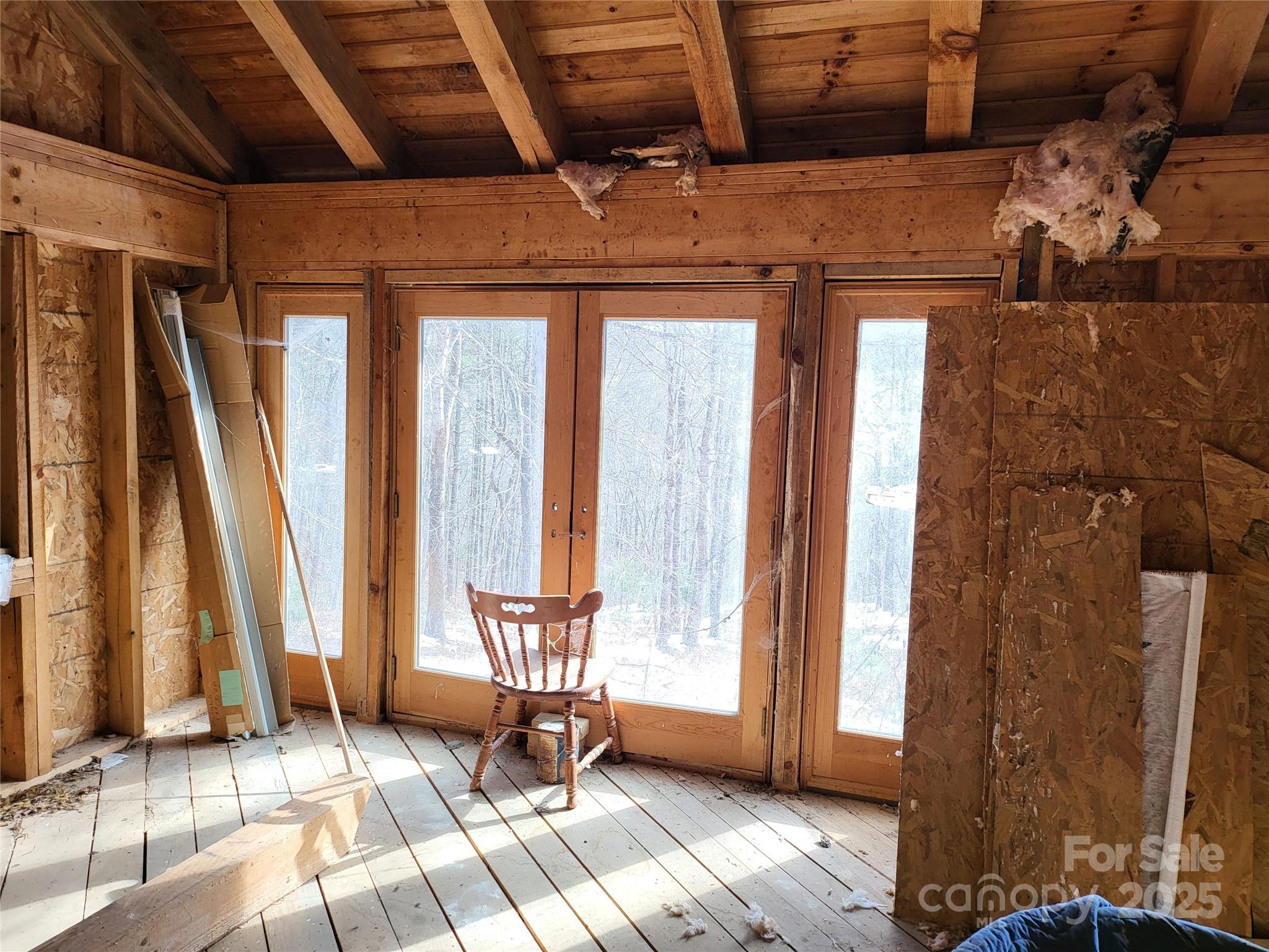 Off Alarka Road Bryson City, NC 28713 - Photo 9 of 43 a living room with a large window and wooden floor