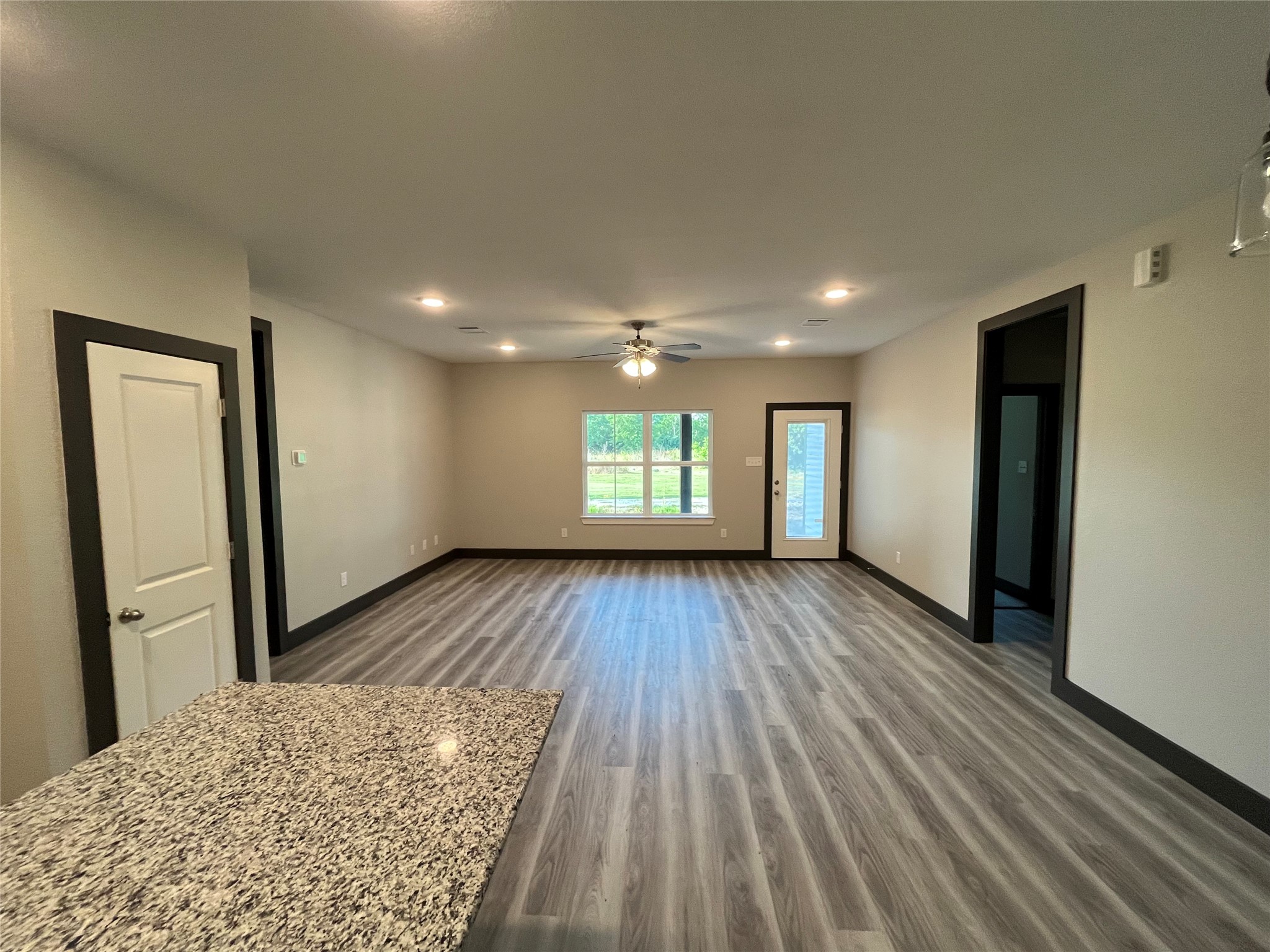 111 Heatherbrook Somerville, TX 77879 - Photo 2 of 11 wooden floor in an empty room with a window