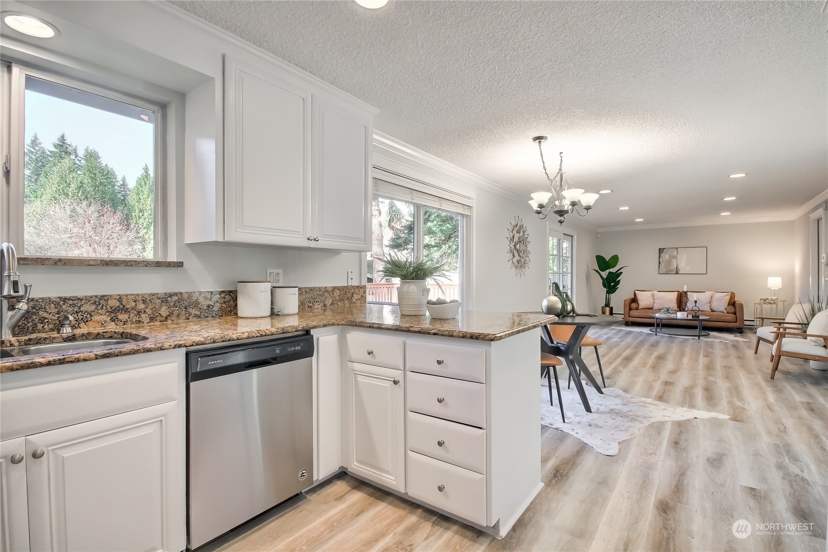 19818 34th Drive Southeast Bothell, WA 98012 - Photo 15 of 34 a kitchen with white cabinets and chandelier