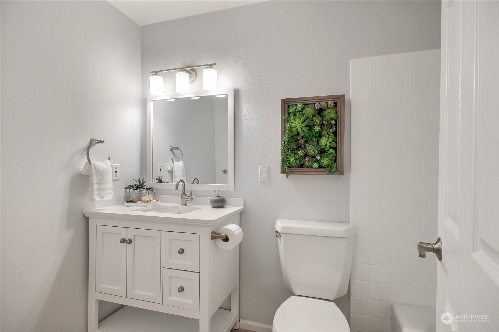 19818 34th Drive Southeast Bothell, WA 98012 - Photo 21 of 34 a bathroom with a toilet a sink and mirror