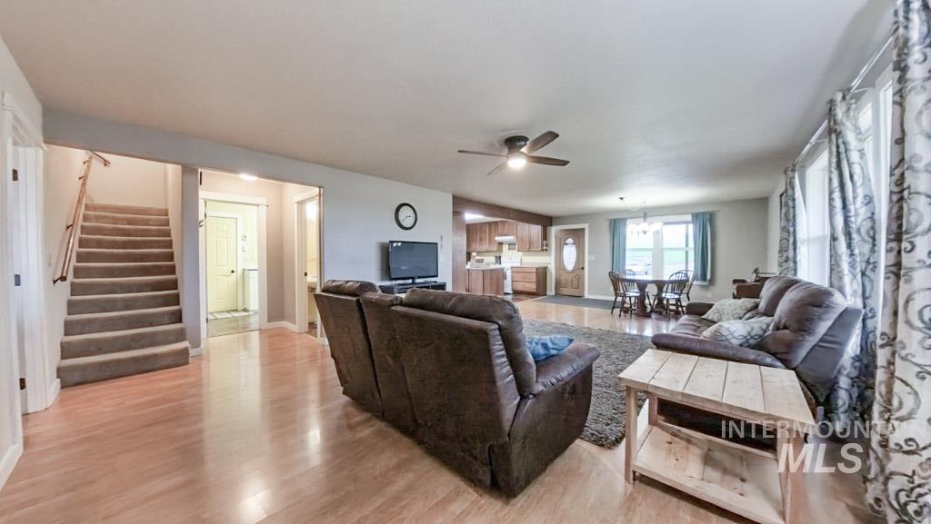 1277 Kennedy Ford Road Potlatch, ID 83855 - Photo 11 of 49 Main level navigation, view of living room, 1/2 bath, laundry room to workshop access. To the left are the stairway to the upstairs, and the primary bedroom doorway.