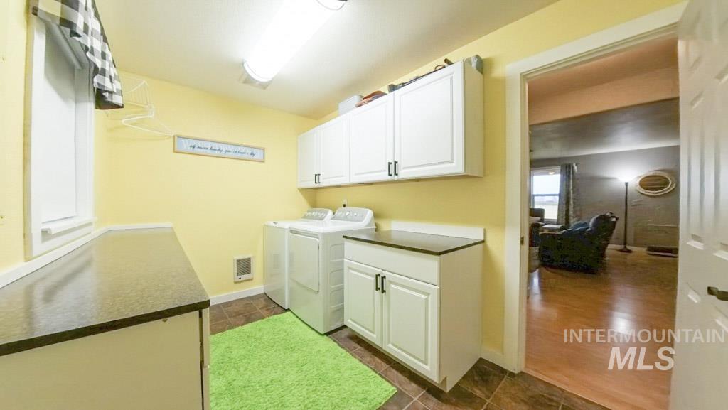 1277 Kennedy Ford Road Potlatch, ID 83855 - Photo 15 of 49 Laundry room with cabinet space, washing machine and dryer, and the counter is plumbing ready for a sink to complete the "mudroom".