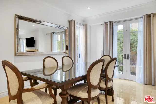 a view of a a dining room with furniture window and wooden floor