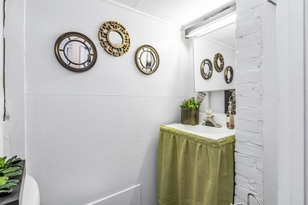 11 Cambridge Street Lawrence, MA 01843 - Photo 38 of 40 a bathroom with a sink and a mirror