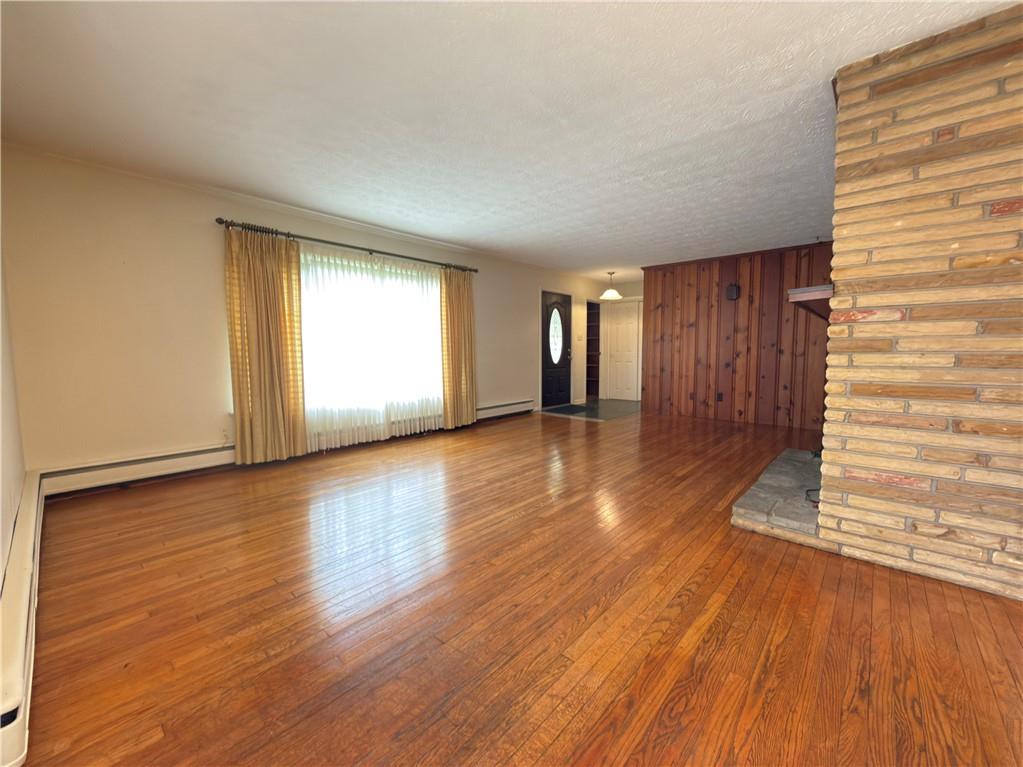 123 Hadley Road Greenville, PA 16125 - Photo 22 of 49 a view of an empty room with wooden floor and a window