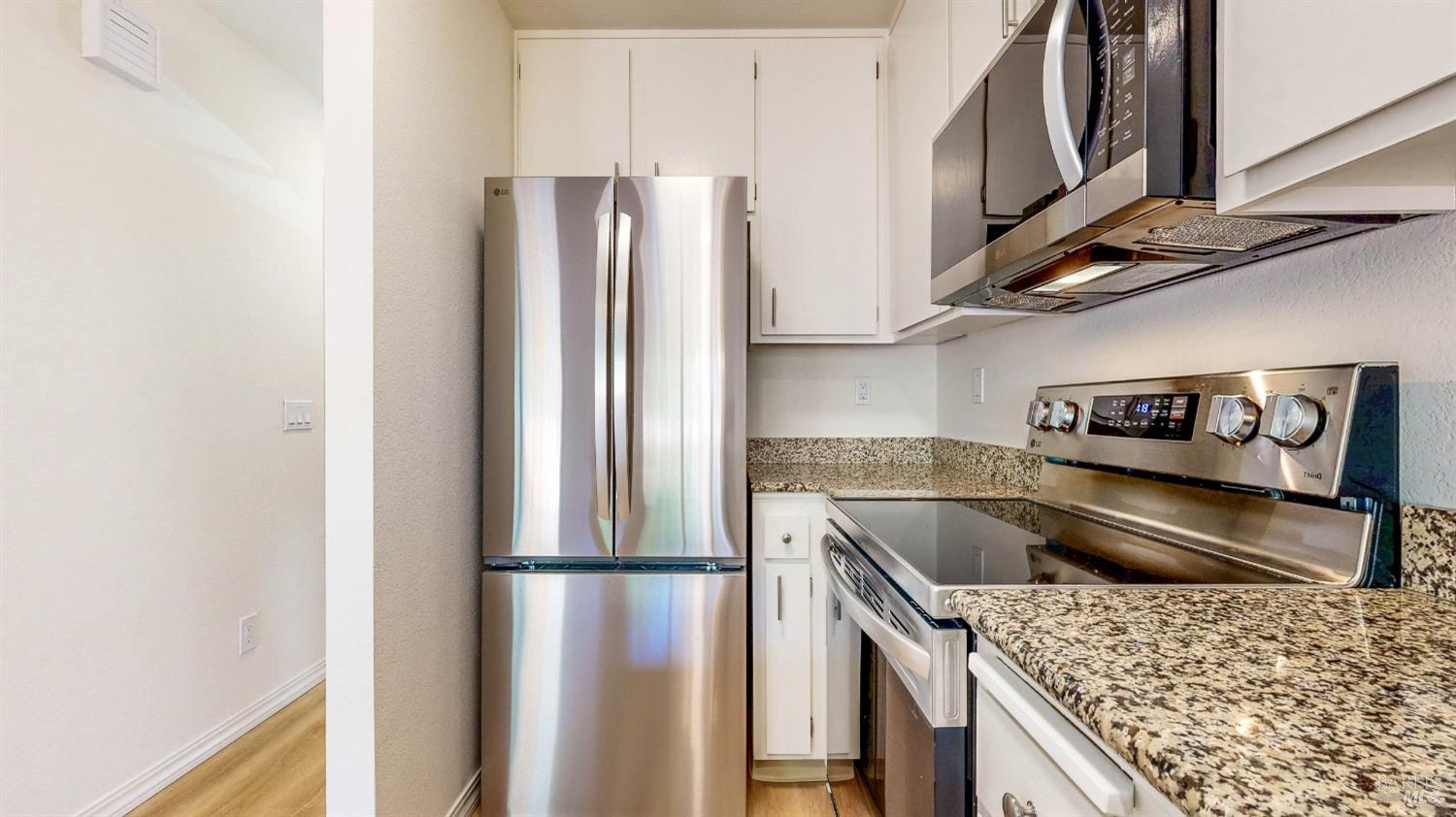 158 North Dutton Avenue Santa Rosa, CA 95401 - Photo 15 of 50 a kitchen with stainless steel appliances granite countertop a refrigerator and a sink