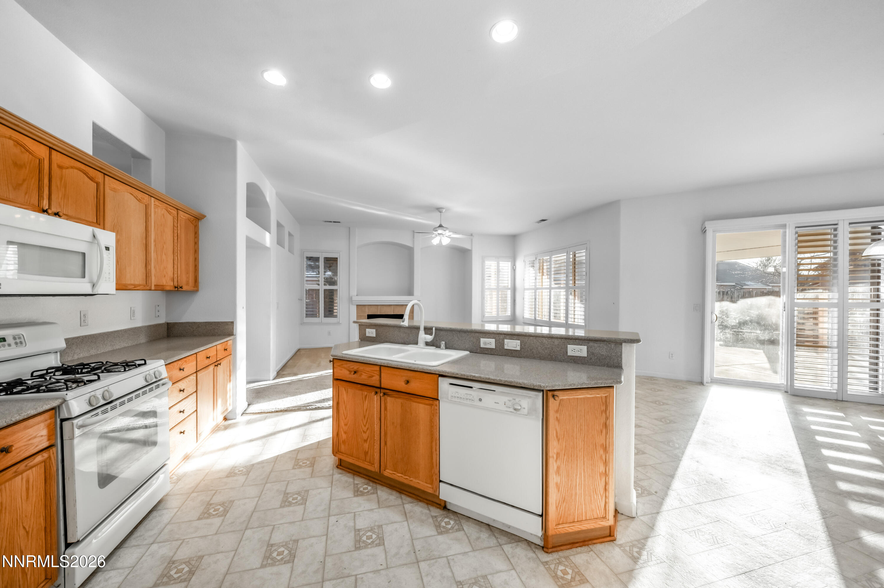 10145 Lucente Way Reno, NV 89521 - Photo 23 of 54 a kitchen with stainless steel appliances granite countertop a stove a sink and a refrigerator