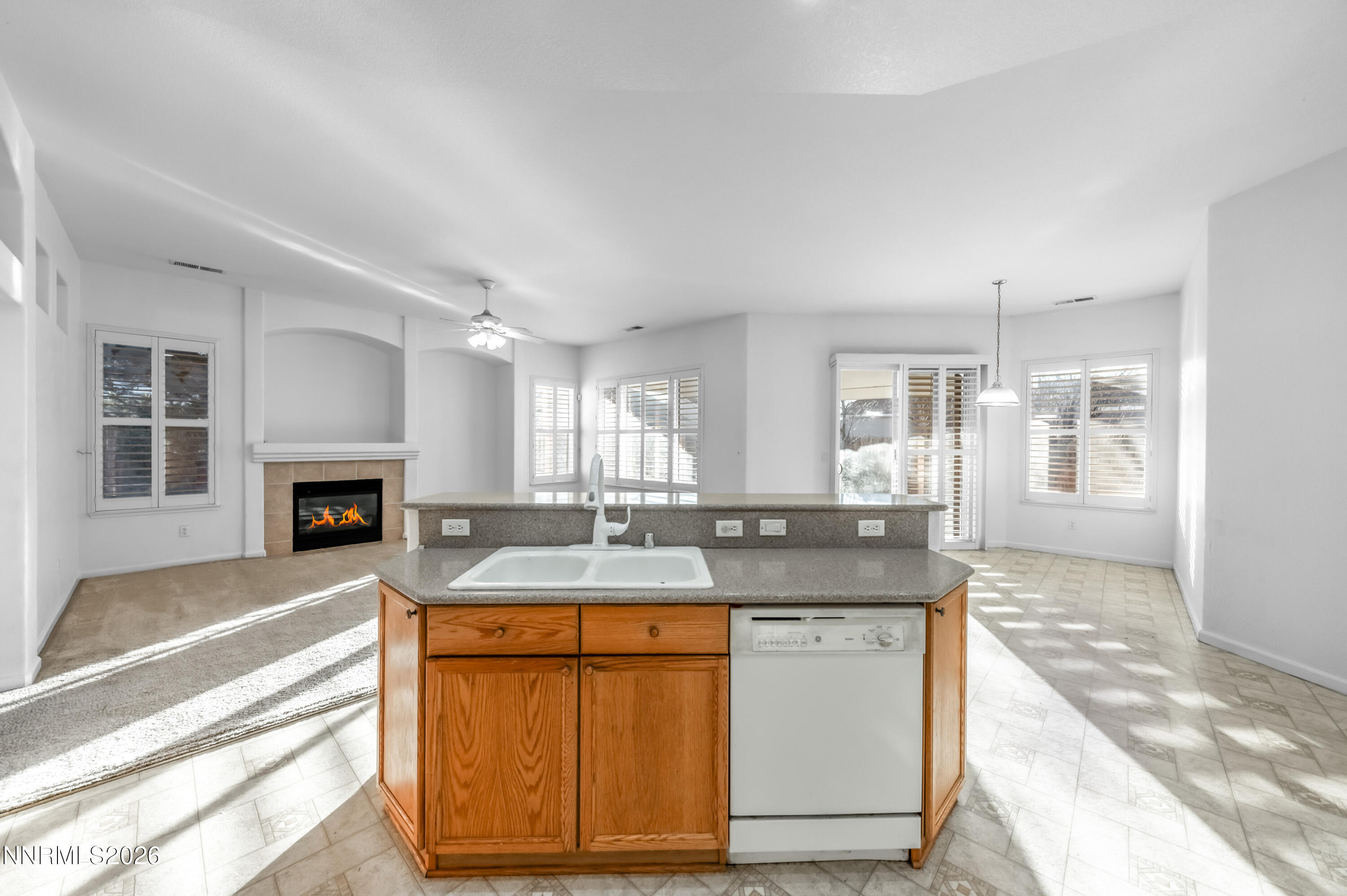 10145 Lucente Way Reno, NV 89521 - Photo 24 of 54 a hall with kitchen island a fireplace and a counter space
