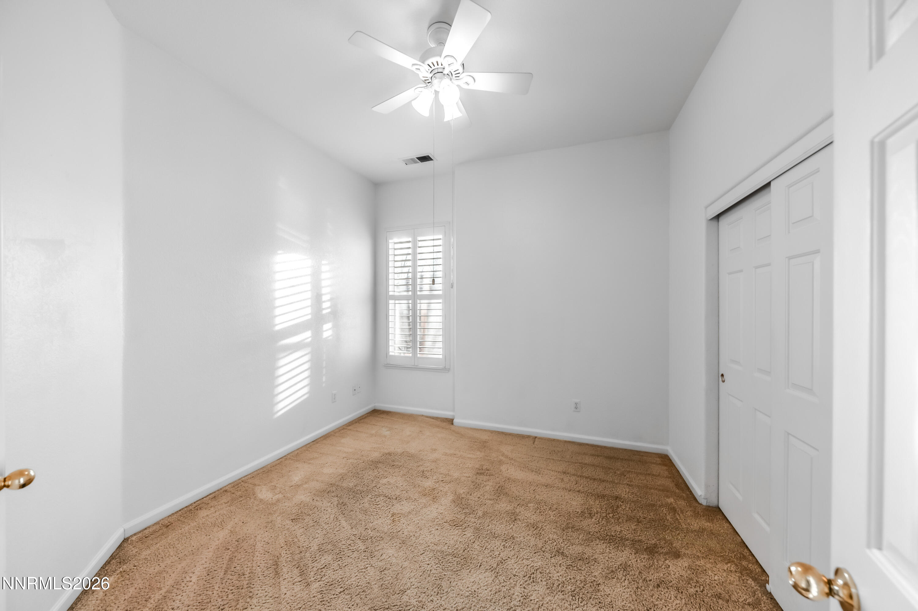 10145 Lucente Way Reno, NV 89521 - Photo 31 of 54 an empty room with windows and fan